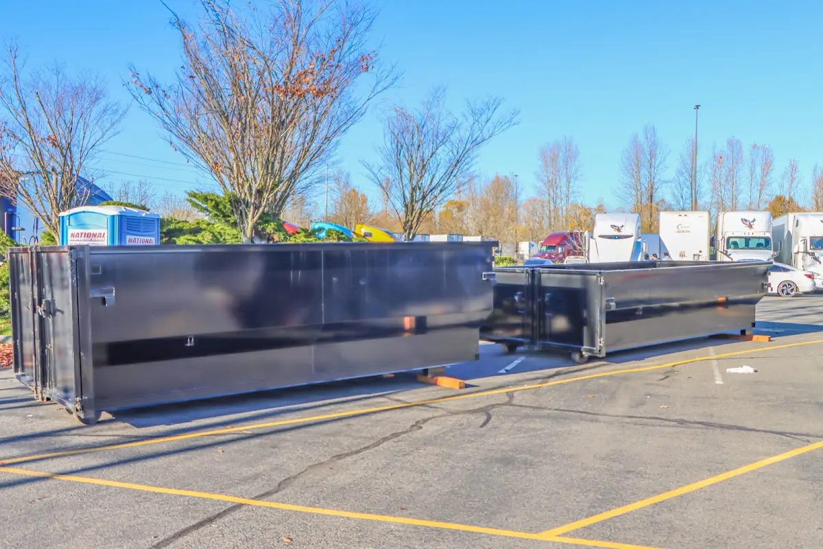 Professional dumpster rental service with roll-off container on residential driveway in Chicago